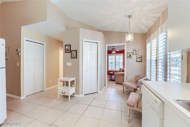 3775 Fieldstone Blvd Unit 104, Naples, FL 34109 - dining space with light tile patterned floors, baseboards, vaulted ceiling, and ceiling fan with notable chandelier