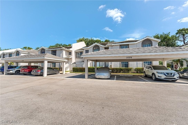 3775 Fieldstone Blvd Unit 104, Naples, FL 34109 - covered parking lot featuring a residential view