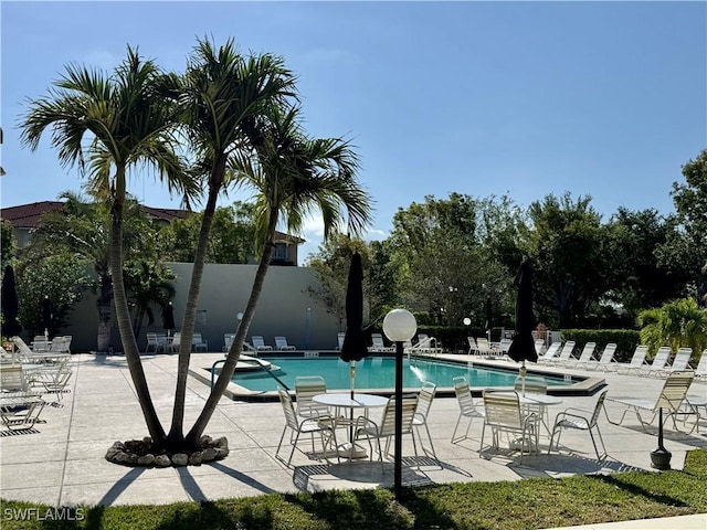 community pool featuring fence and a patio area