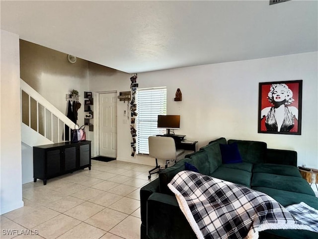 living area with light tile patterned floors and stairway