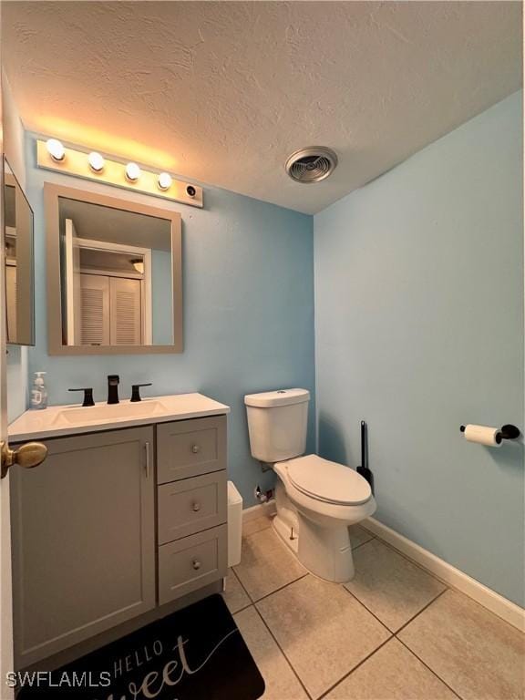 bathroom with toilet, baseboards, visible vents, and tile patterned flooring