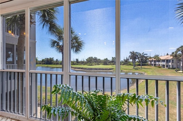 unfurnished sunroom with a water view