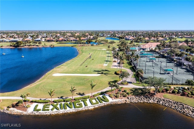 aerial view featuring a water view, view of golf course, and a residential view