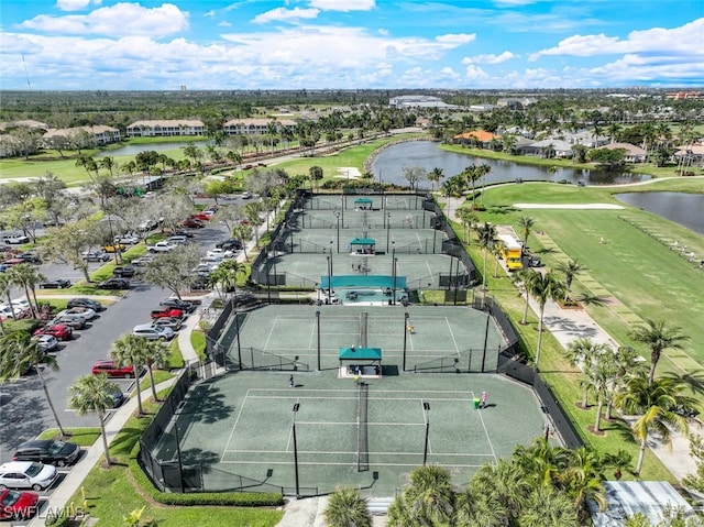 birds eye view of property with a water view and golf course view
