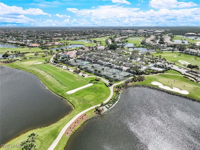 birds eye view of property with a water view and golf course view