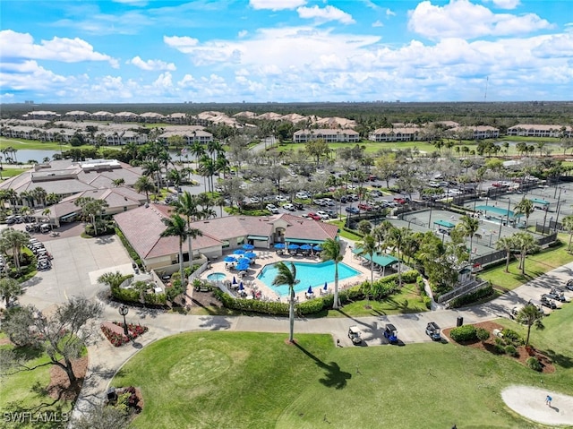 bird's eye view featuring a water view, view of golf course, and a residential view