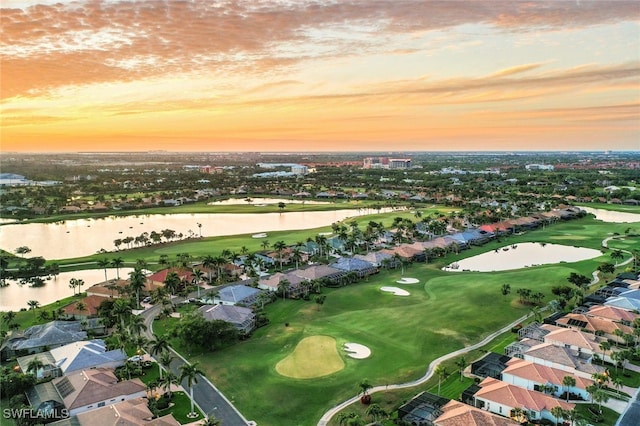 birds eye view of property with a residential view, a water view, and golf course view