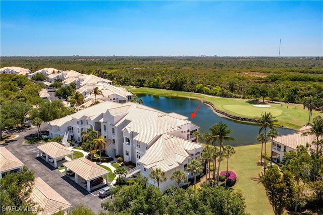 birds eye view of property with a water view, view of golf course, and a forest view