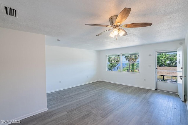 3225 E Riverside Dr Unit 26B, Fort Myers, FL 33916 - unfurnished room with a textured ceiling, healthy amount of natural light, wood finished floors, and a ceiling fan
