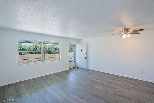 3225 E Riverside Dr Unit 26B, Fort Myers, FL 33916 - unfurnished living room featuring dark wood finished floors, a textured ceiling, ceiling fan, and baseboards