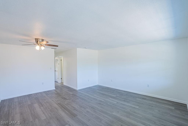 3225 E Riverside Dr Unit 26B, Fort Myers, FL 33916 - empty room featuring a ceiling fan, wood finished floors, and baseboards