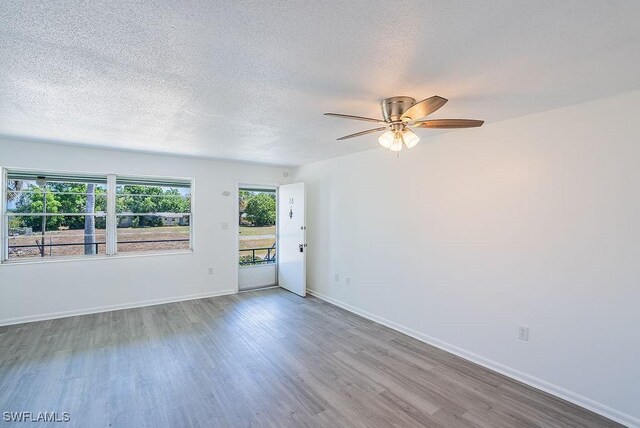 3225 E Riverside Dr Unit 26B, Fort Myers, FL 33916 - empty room with wood finished floors, ceiling fan, a textured ceiling, and baseboards