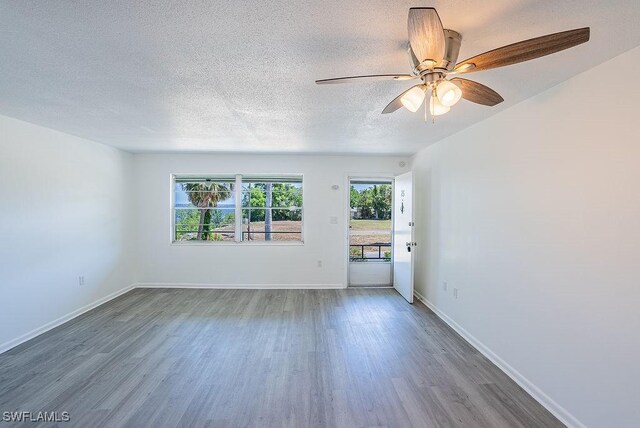 3225 E Riverside Dr Unit 26B, Fort Myers, FL 33916 - unfurnished room featuring wood finished floors, ceiling fan, a textured ceiling, and baseboards
