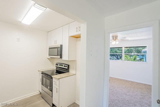 3225 E Riverside Dr Unit 26B, Fort Myers, FL 33916 - kitchen featuring stainless steel appliances, light countertops, white cabinets, baseboards, and a ceiling fan