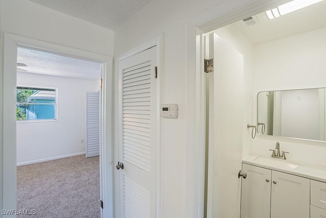 3225 E Riverside Dr Unit 26B, Fort Myers, FL 33916 - bathroom with vanity, a textured ceiling, and baseboards