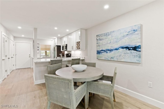 261 S Collier Blvd Unit 304, Marco Island, FL 34145 - dining space featuring recessed lighting, light wood finished floors, and baseboards