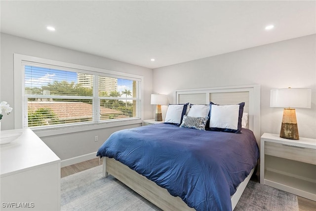261 S Collier Blvd Unit 304, Marco Island, FL 34145 - bedroom with baseboards, recessed lighting, and light wood finished floors