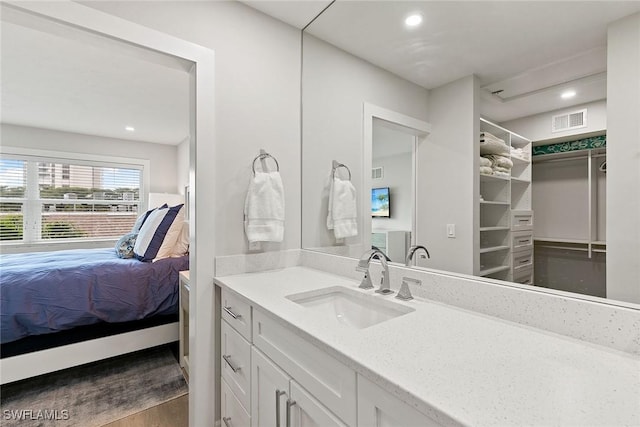261 S Collier Blvd Unit 304, Marco Island, FL 34145 - full bath with visible vents, wood finished floors, vanity, connected bathroom, and recessed lighting