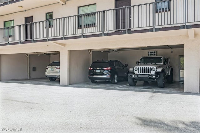 view of parking / parking lot featuring a garage