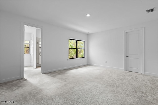 carpeted spare room featuring baseboards and recessed lighting