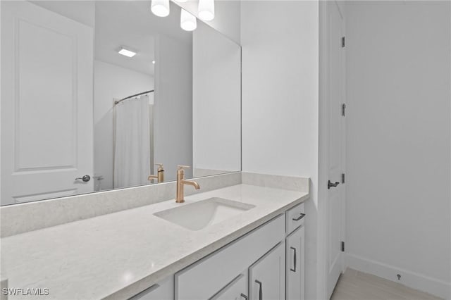 bathroom featuring vanity and baseboards