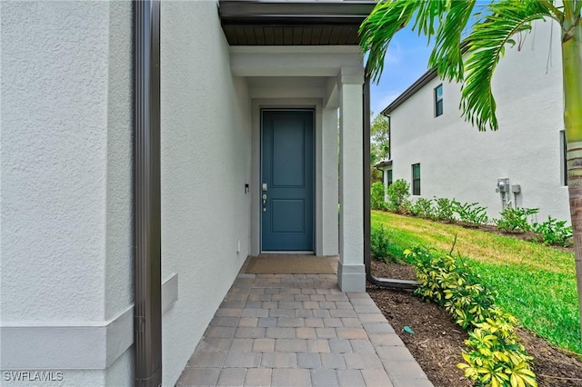 property entrance featuring stucco siding