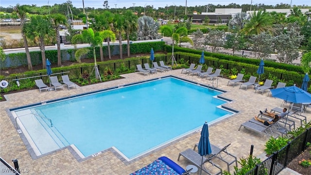 community pool featuring a patio area and fence