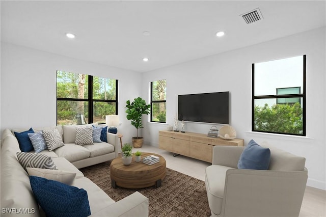 living area featuring recessed lighting and baseboards