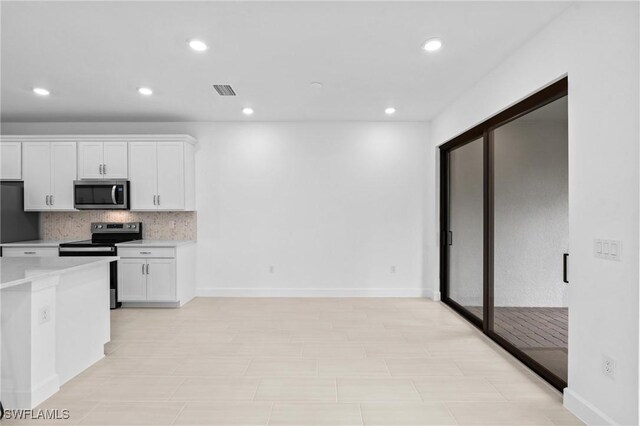 kitchen with appliances with stainless steel finishes, white cabinetry, decorative backsplash, light countertops, and recessed lighting