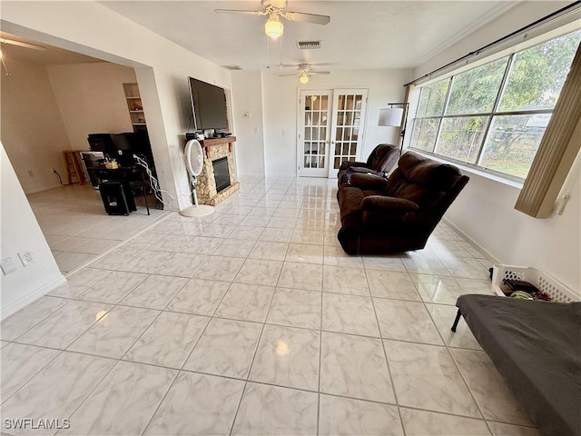 314 Vermont Way, Lehigh Acres, FL 33936 - living room with a ceiling fan, a fireplace, and french doors