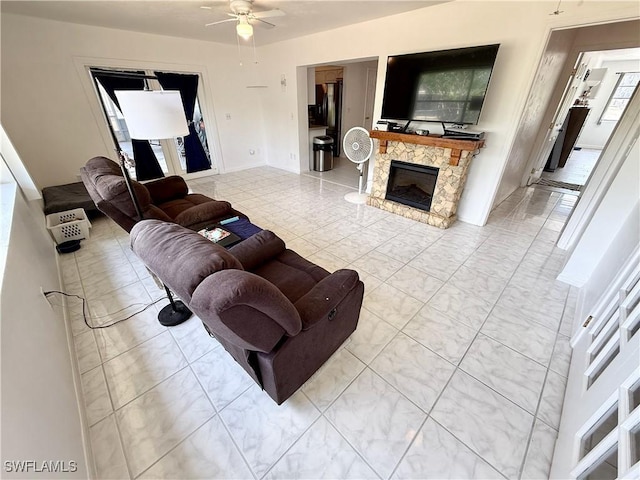 314 Vermont Way, Lehigh Acres, FL 33936 - living room with a ceiling fan and a fireplace