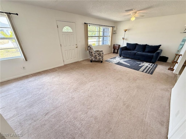 314 Vermont Way, Lehigh Acres, FL 33936 - carpeted living area with ceiling fan and a textured ceiling