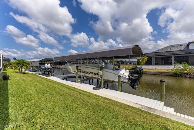 view of dock featuring a lawn, a water view, and boat lift