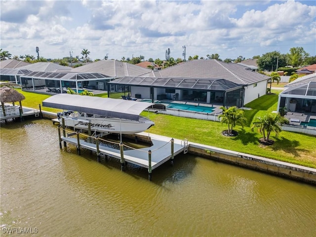 dock area with boat lift, a residential view, a water view, and an outdoor pool