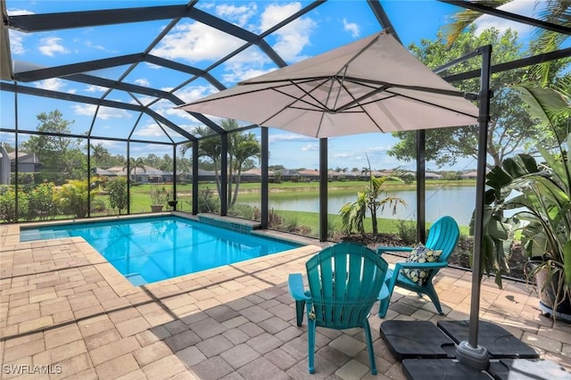 swimming pool featuring a patio area, a water view, and a lanai