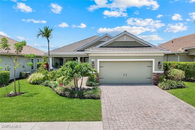 ranch-style house with a front yard, an attached garage, decorative driveway, and stucco siding