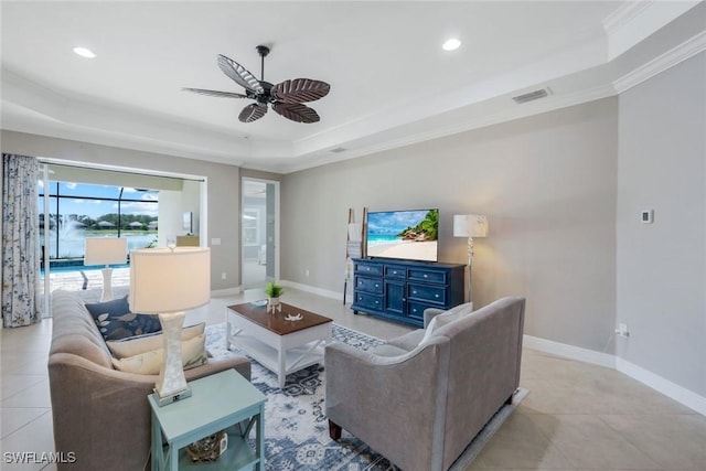 living area featuring a tray ceiling, a ceiling fan, recessed lighting, baseboards, and crown molding