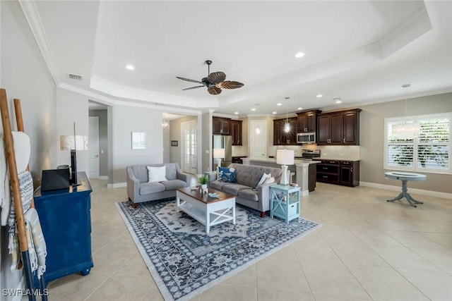 living area with a raised ceiling, light tile patterned floors, a ceiling fan, crown molding, and recessed lighting