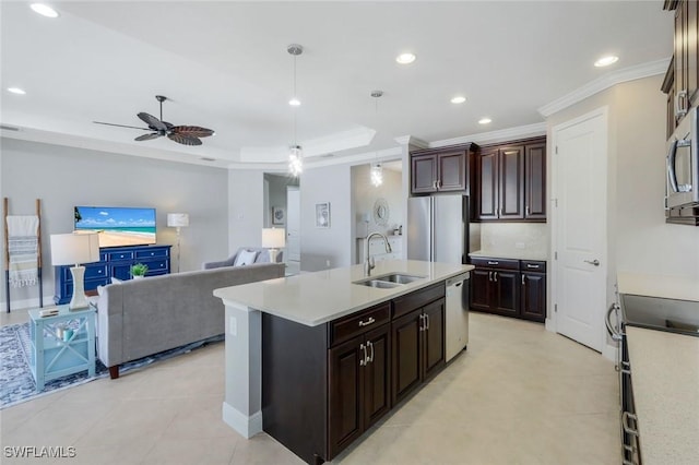kitchen featuring stainless steel appliances, a sink, light countertops, ornamental molding, and a ceiling fan