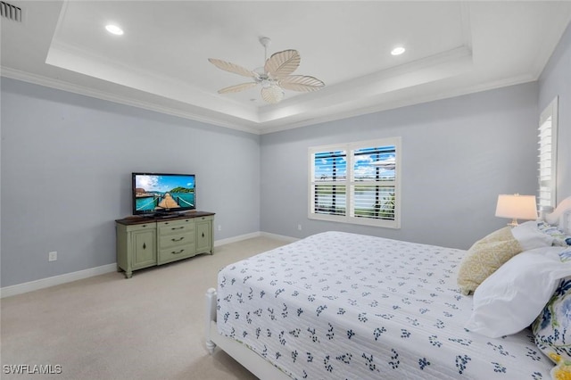 bedroom featuring a tray ceiling, recessed lighting, light carpet, crown molding, and a ceiling fan