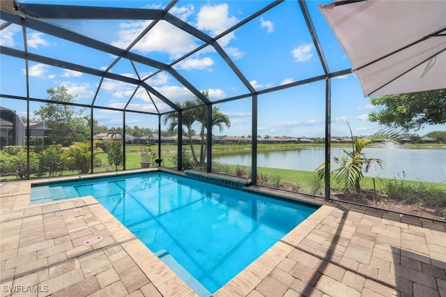 outdoor pool with a water view, a patio, and glass enclosure