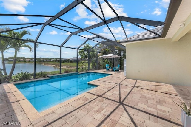 outdoor pool with a water view, a patio area, and glass enclosure