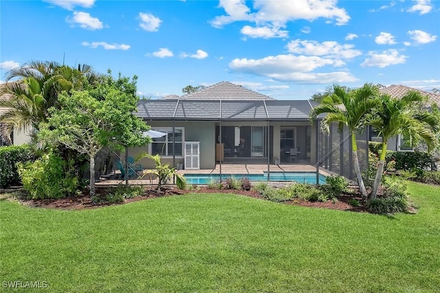 back of property featuring a lawn, an outdoor pool, a lanai, stucco siding, and a patio
