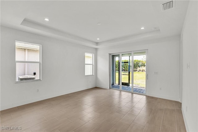 44332 Panther Dr, Punta Gorda, FL 33982 - unfurnished room featuring a raised ceiling, baseboards, recessed lighting, and wood finished floors