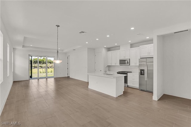 kitchen with a sink, open floor plan, visible vents, appliances with stainless steel finishes, and recessed lighting