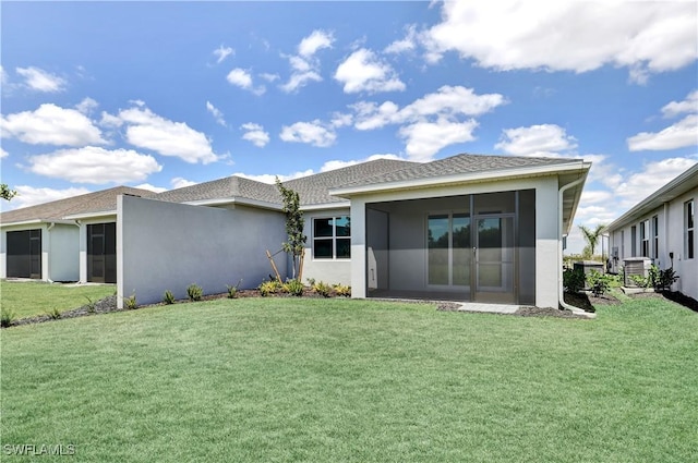 back of property with a yard, stucco siding, and cooling unit