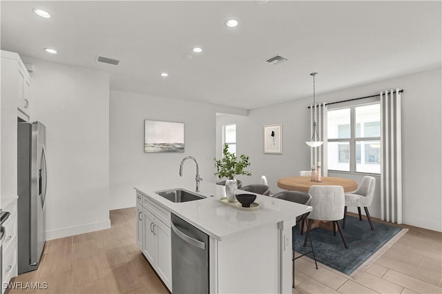 44332 Panther Dr, Punta Gorda, FL 33982 - kitchen featuring stainless steel appliances, a sink, healthy amount of natural light, white cabinetry, and recessed lighting