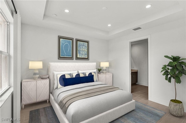 44332 Panther Dr, Punta Gorda, FL 33982 - bedroom with recessed lighting, a raised ceiling, baseboards, and ensuite bath