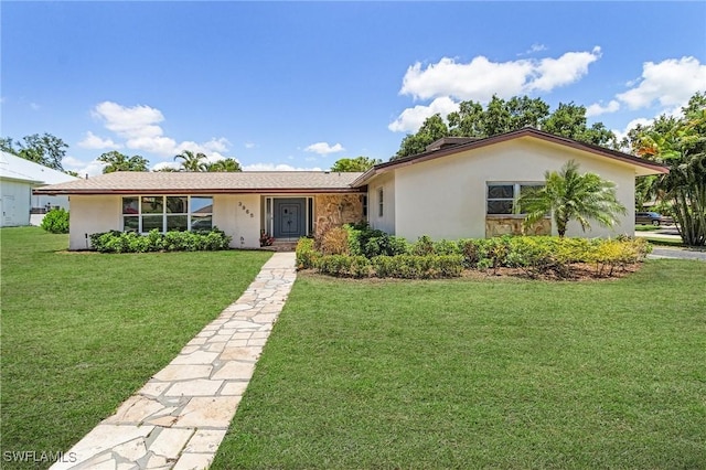 3965 W Riverside Dr, Fort Myers, FL 33901 - ranch-style house featuring a front lawn, stucco siding, and stone siding