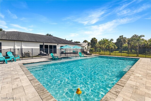 1330 Rock Rd, Naples, FL 34120 - view of swimming pool with a fenced in pool, fence, and a patio